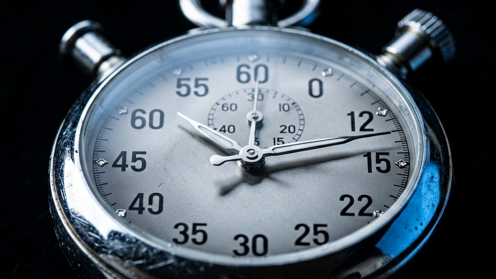 Extreme close-up of a mechanical stopwatch, second hand frozen at a specific position, chrome casing catching cold directional lighting